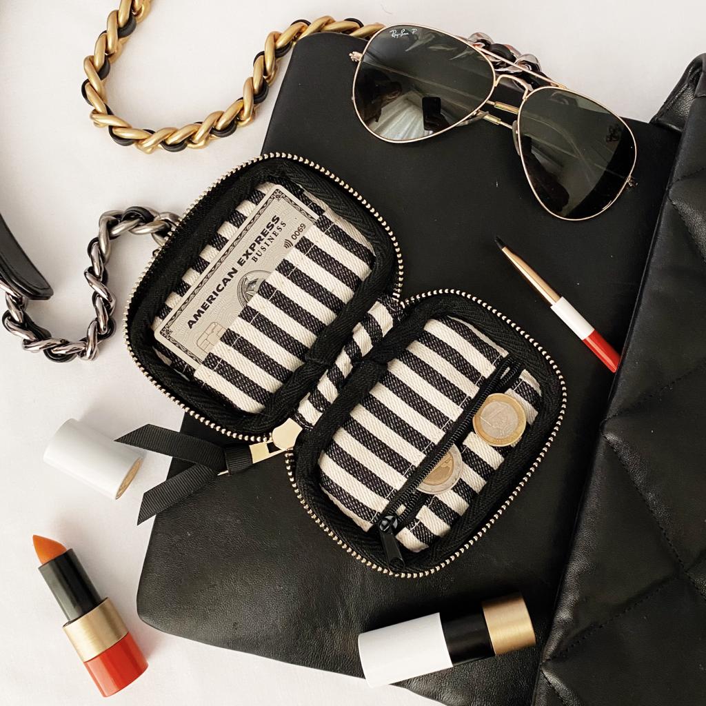 Bag-all Small Wallet Pink/Blush with Black Piping featuring striped interior compartments, gold zipper detail, and card slots, styled with sunglasses and lipstick for everyday elegance and organization