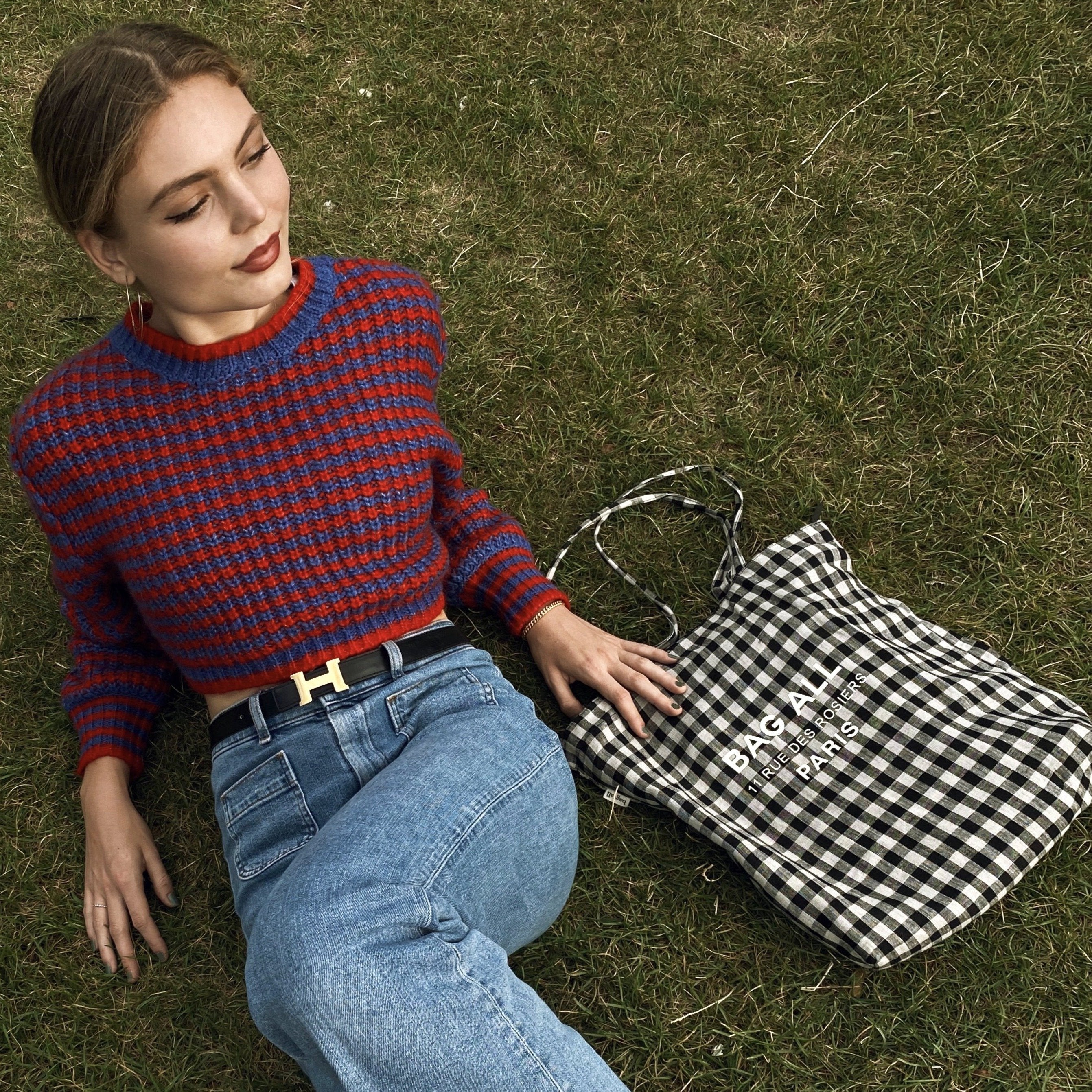 Bag-all Paris Le Marais Gingham Tote with zipper and inner pocket shown on grass, black and white checkered pattern, spacious design, perfect for everyday use and travel