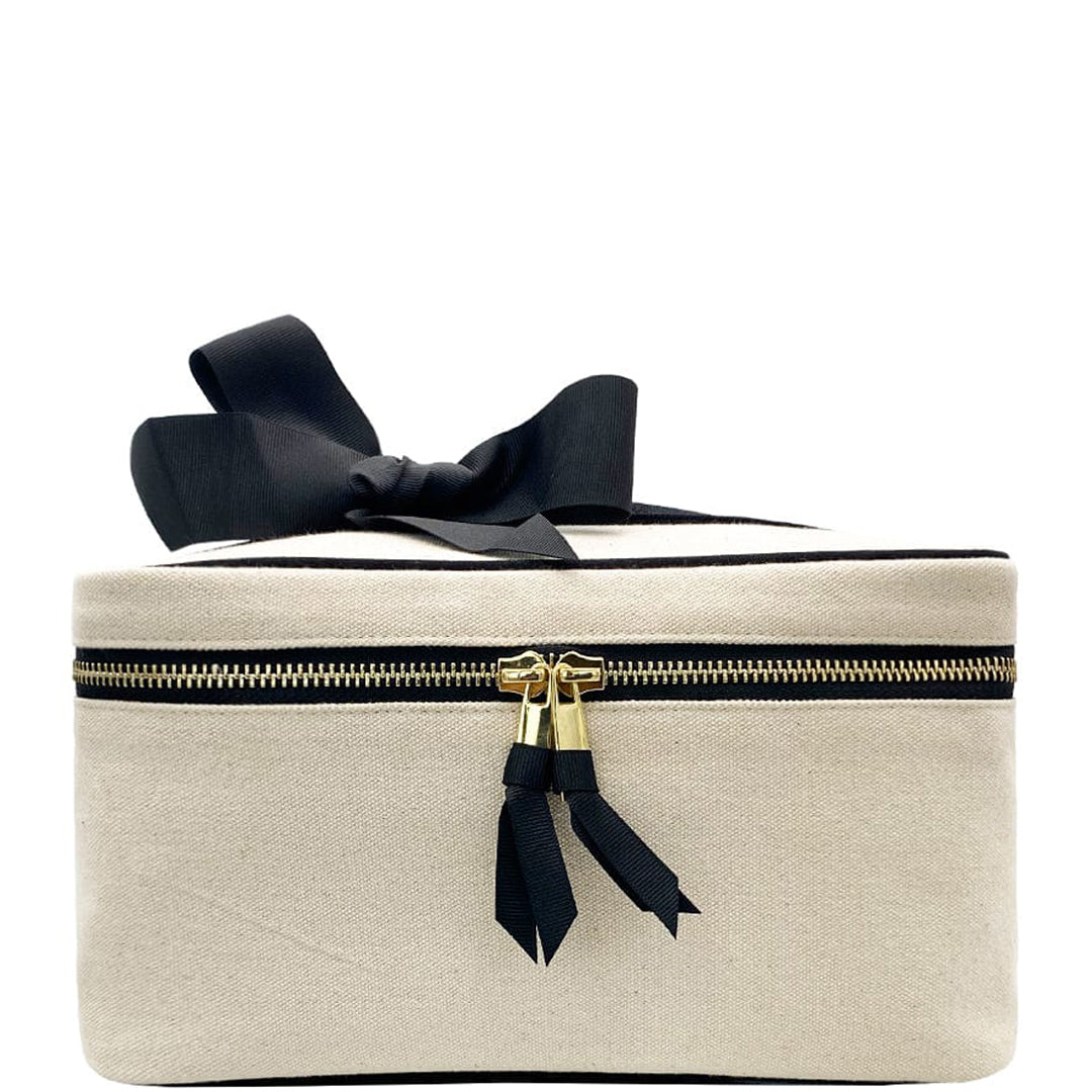 Bag-all Medium Box Makeup & Toiletry Case in cream cotton with gold zipper, black ribbon bow and striped interior lining for travel organization