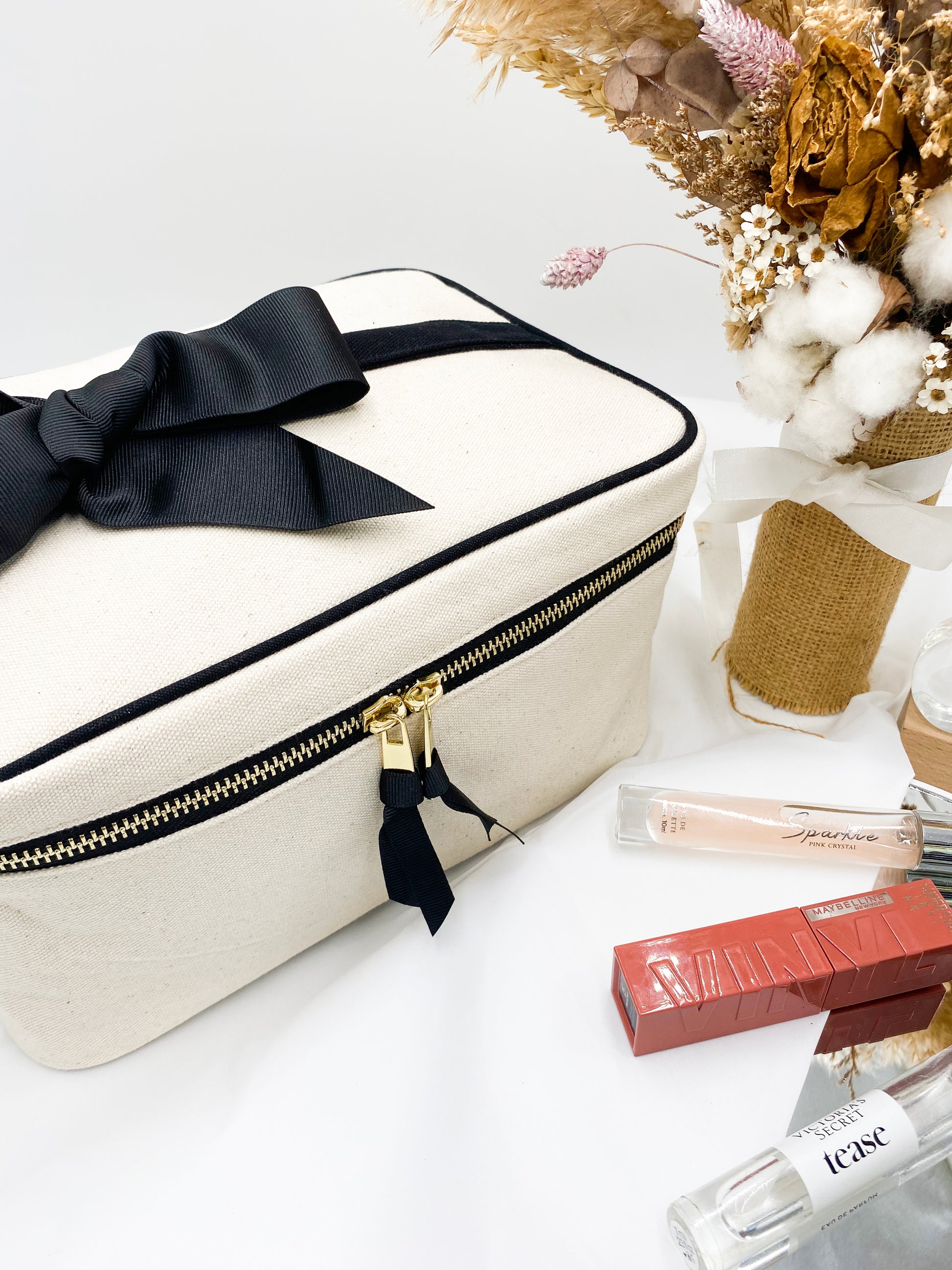 Bag-all Medium Box Makeup & Toiletry Case in cream cotton with black bow, gold zipper and striped interior - perfect for travel organization and beauty essentials