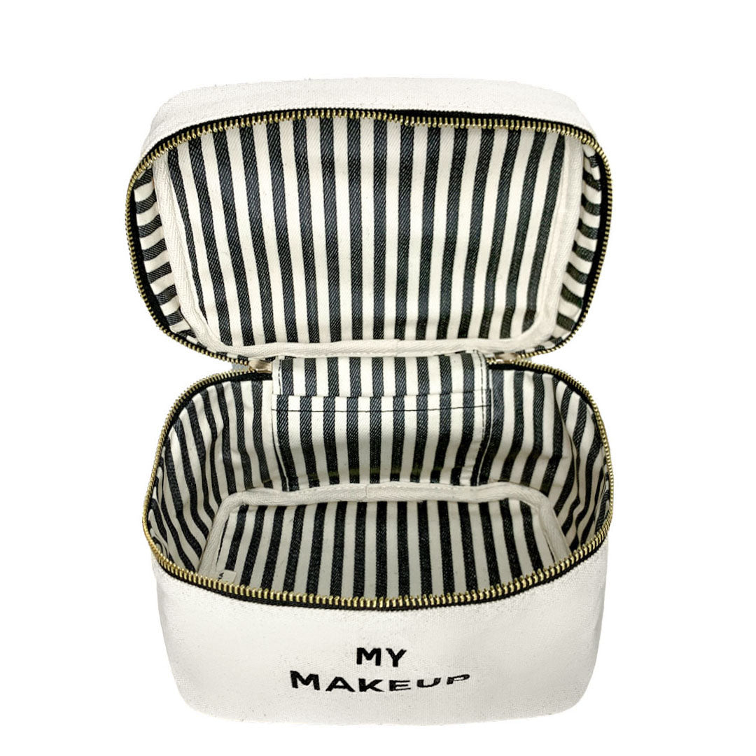 Bag-all My Makeup Cosmetic Box in cream with black and white striped interior lining, waterproof organizing case for beauty essentials and toiletries, featuring gold zipper detail