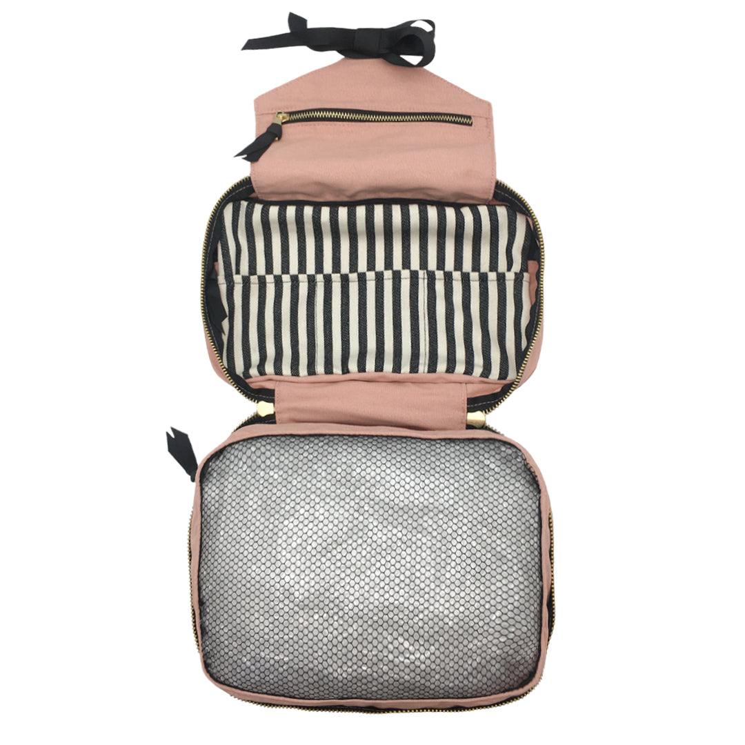 Bag-all Folding Toiletry Case in pink with black ribbon, featuring striped interior compartments, mesh storage section, and multiple organizing pockets for travel essentials