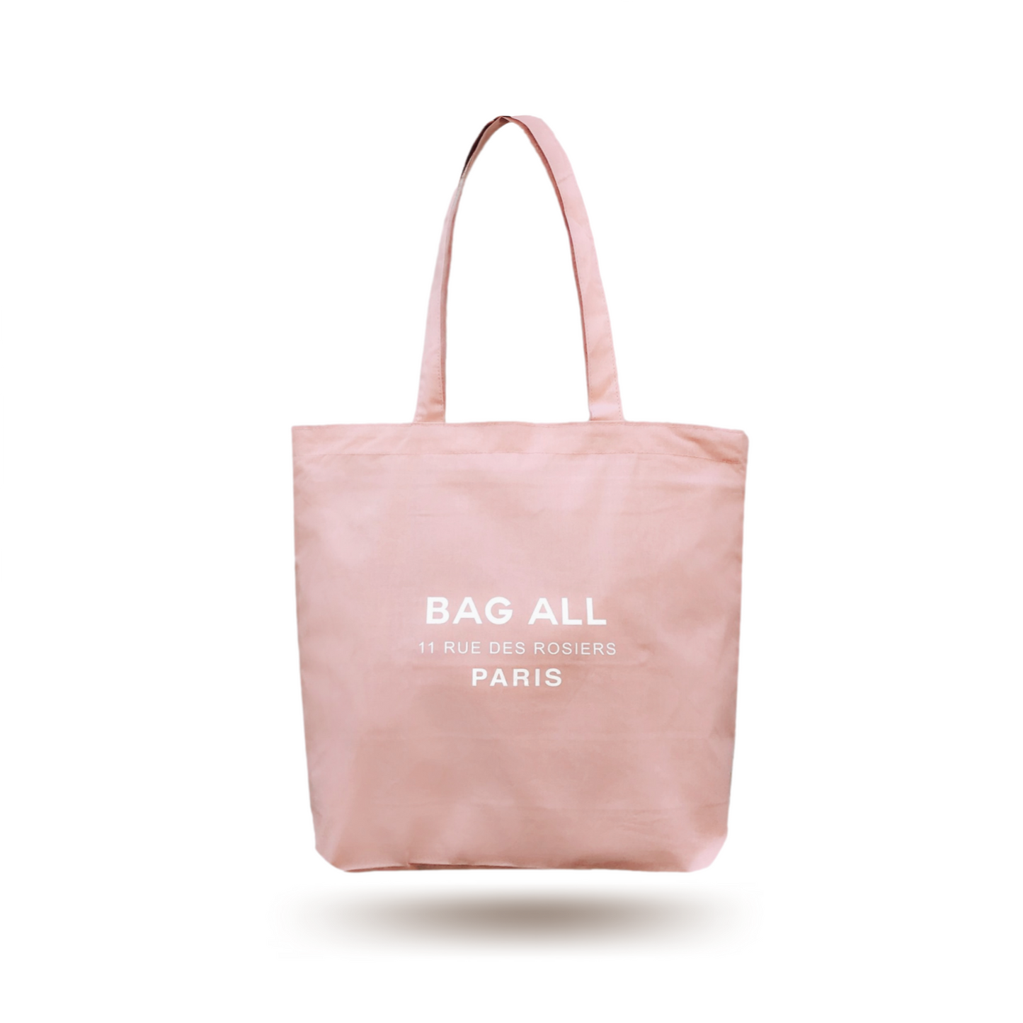 Bag-all Paris Le Marais Tote in blush pink with white logo, featuring zipper closure and interior pocket. Cotton canvas everyday tote with long handles and modern design.