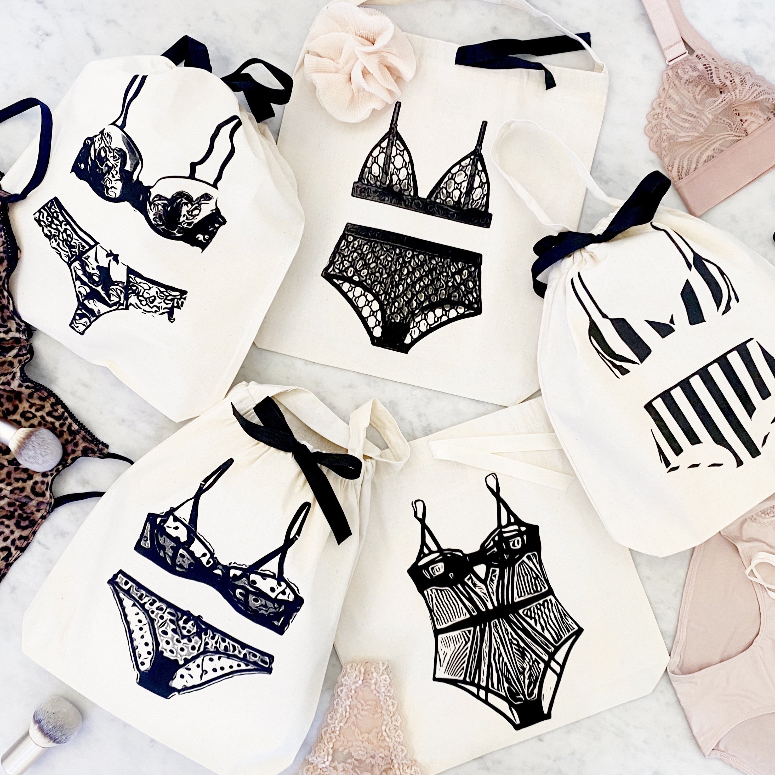 Bag-all Polkadot Lingerie Travel Bag in cream with black ribbon ties featuring illustrated lingerie sets in classic designs - perfect for organizing delicates and travel storage