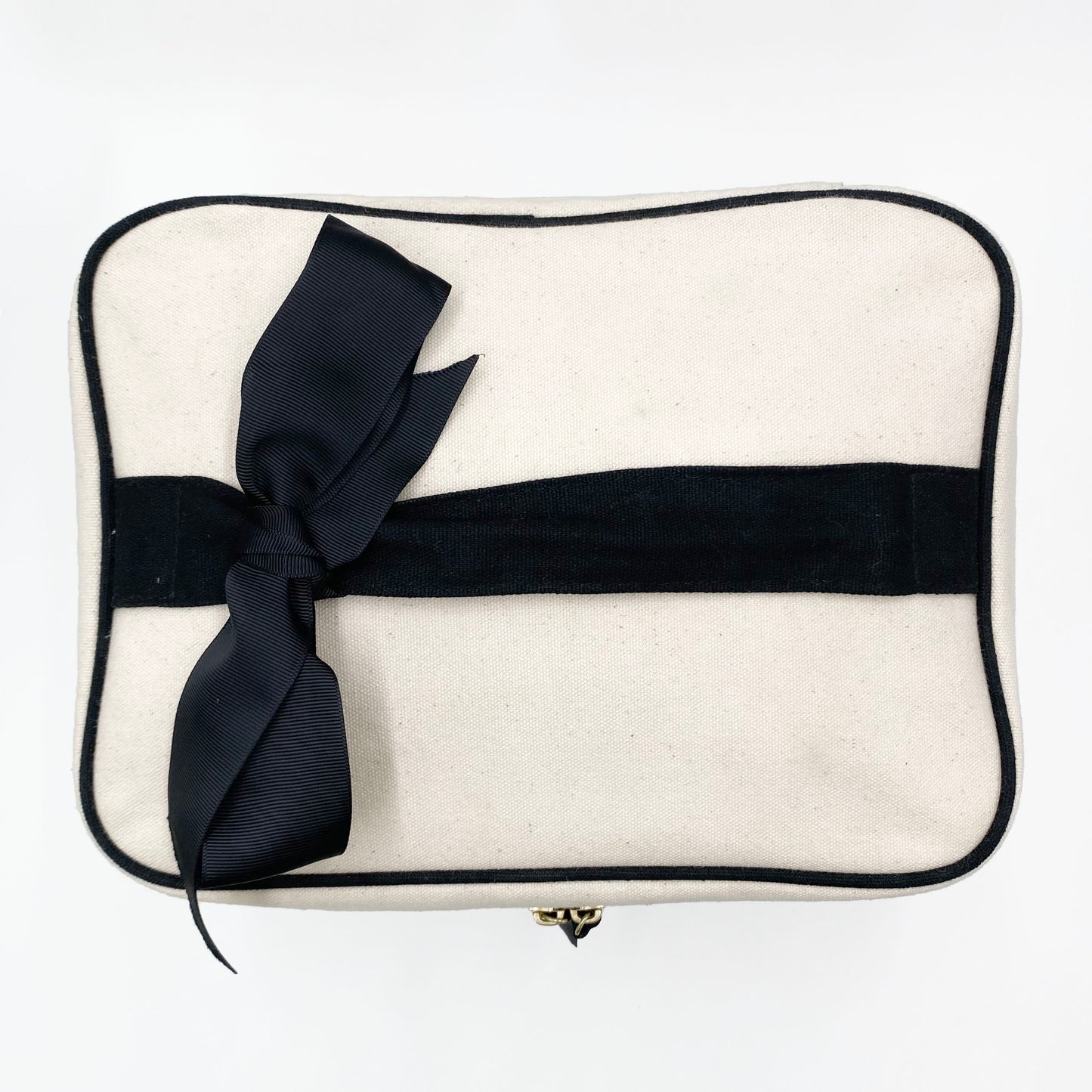 Bag-all My Vanity Large Beauty Box in cream canvas with black trim and removable bow, featuring waterproof lining and spacious storage for cosmetics and toiletries