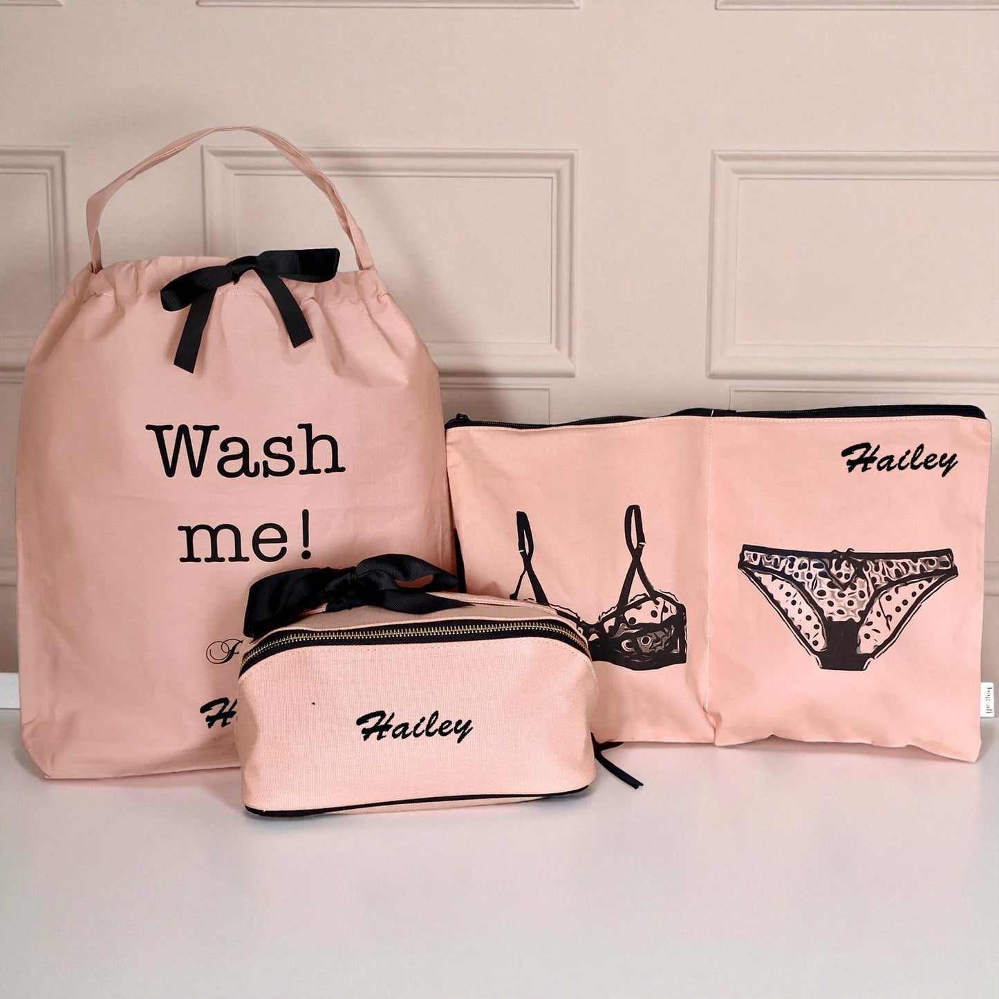 Bag-all pink blush luggage organizer set with wash bag, underwear bag, and makeup pouch with black accents and personalized name Hailey
