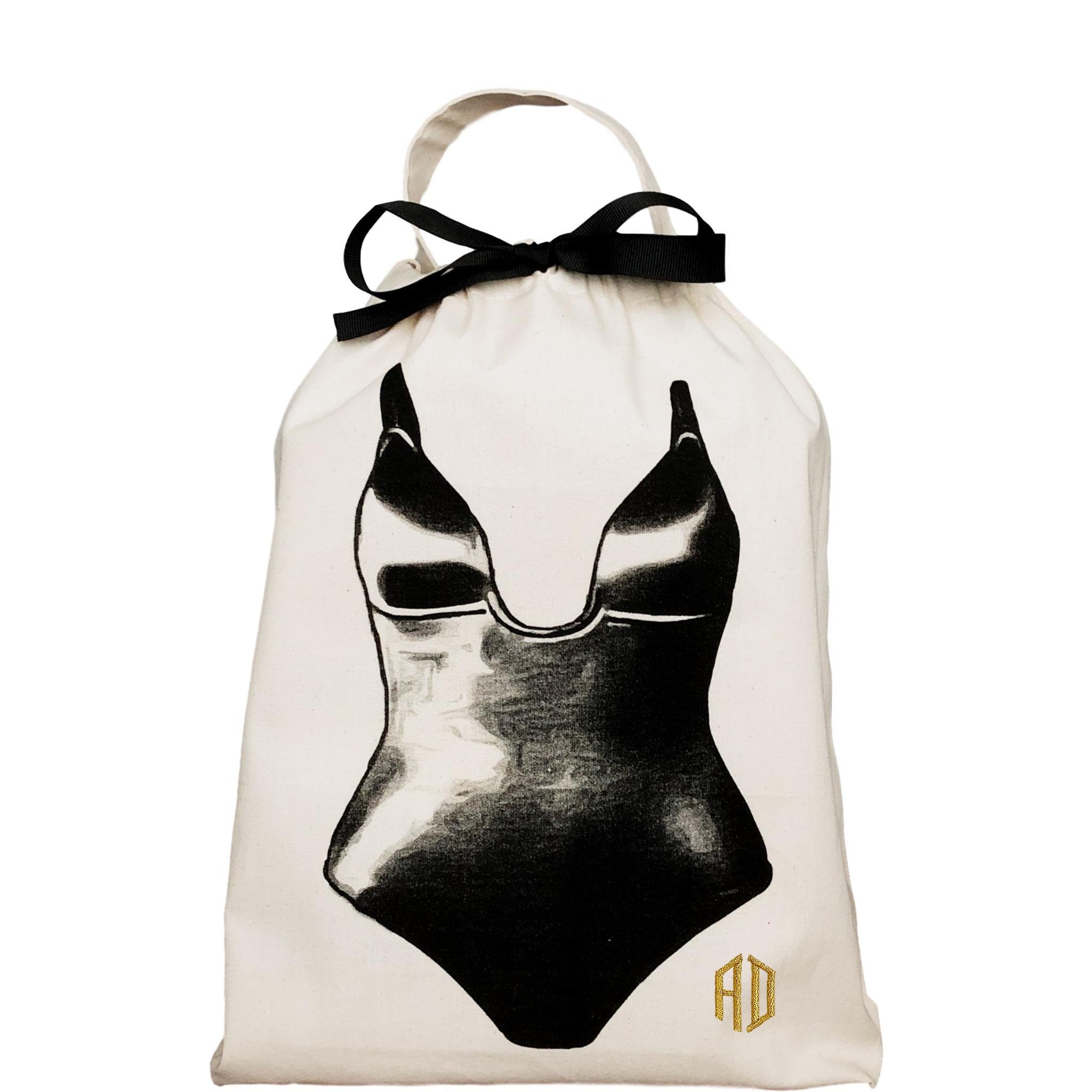 Bag-all Shapewear Travel Bag in cream cotton featuring black swimsuit illustration and ribbon closure, perfect for organizing shapewear at home or during travel