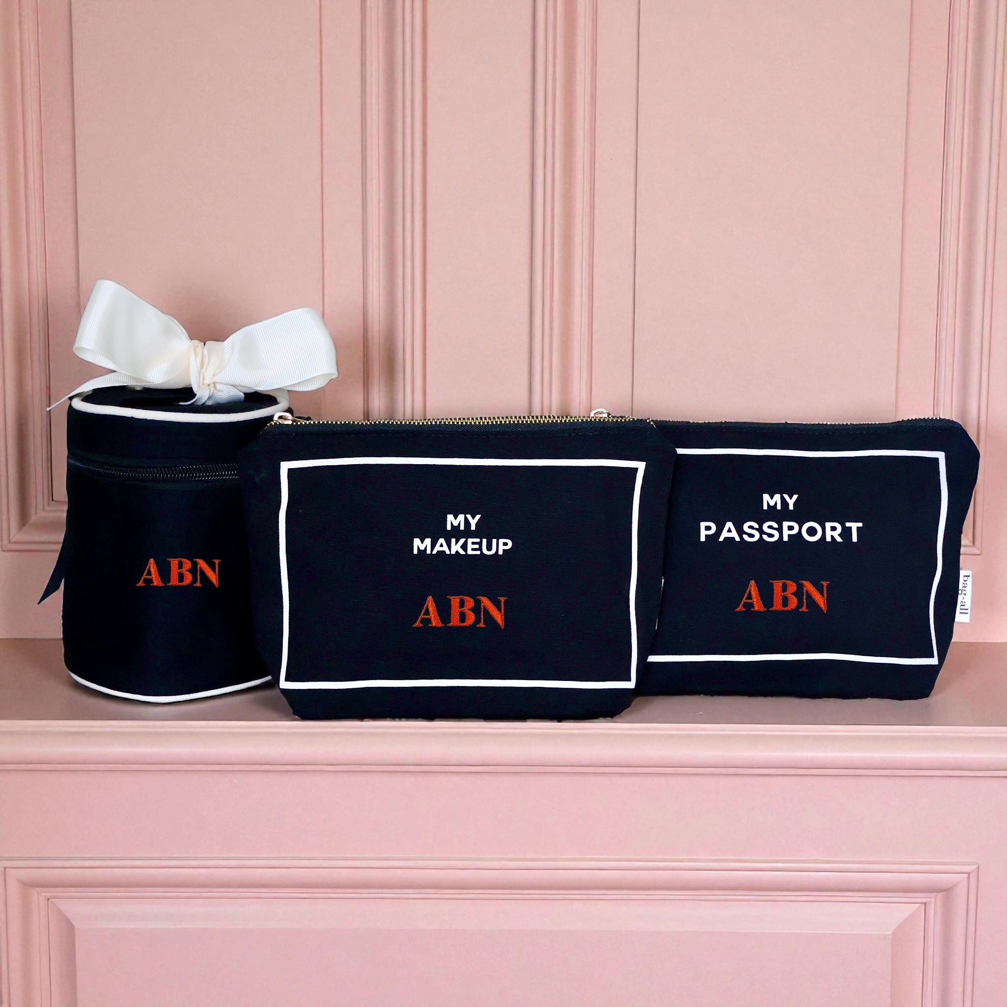 Bag-all black 3-pack travel organizers for makeup, passport, and liquids with white trim and red ABN initials
