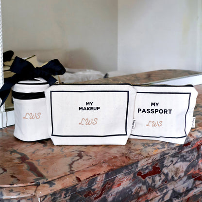 Bag-all cream 3-pack Carry On Essentials set with passport, liquid, and makeup organizers on marble surface