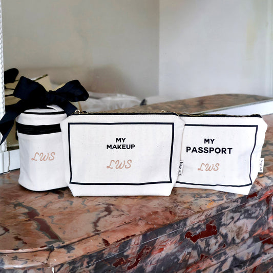 Bag-all cream 3-pack Carry On Essentials set with passport, liquid, and makeup organizers on marble surface