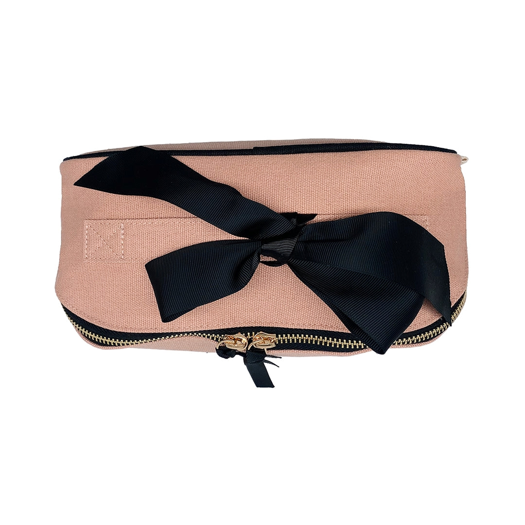 Bag-all blush pink makeup bag with elegant black bow, gold zipper detail, perfect for organizing cosmetics and travel essentials, stylish organizational accessory