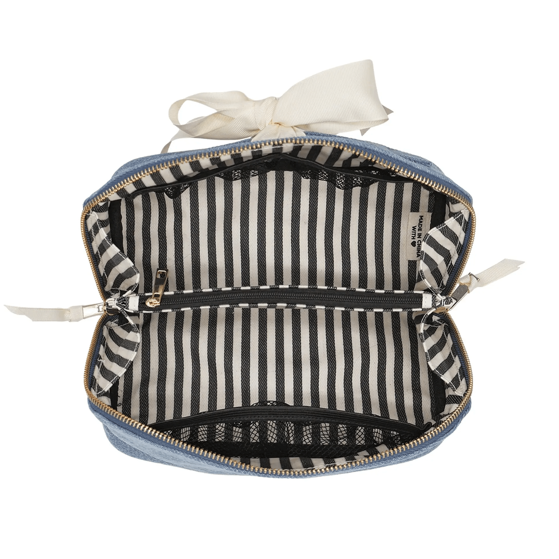 Bag-all expandable denim makeup bag with striped lining, gold zipper, and durable recycled grosgrain ribbon organizer.