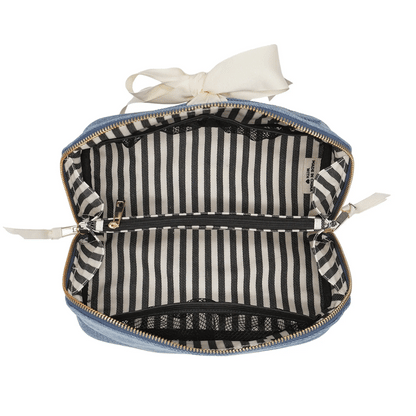 Bag-all expandable denim makeup bag with striped lining, gold zipper, and durable recycled grosgrain ribbon organizer.