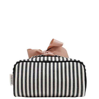 Bag-all expandable striped makeup bag with gold zipper and pink bow, perfect for stylish organization and travel.