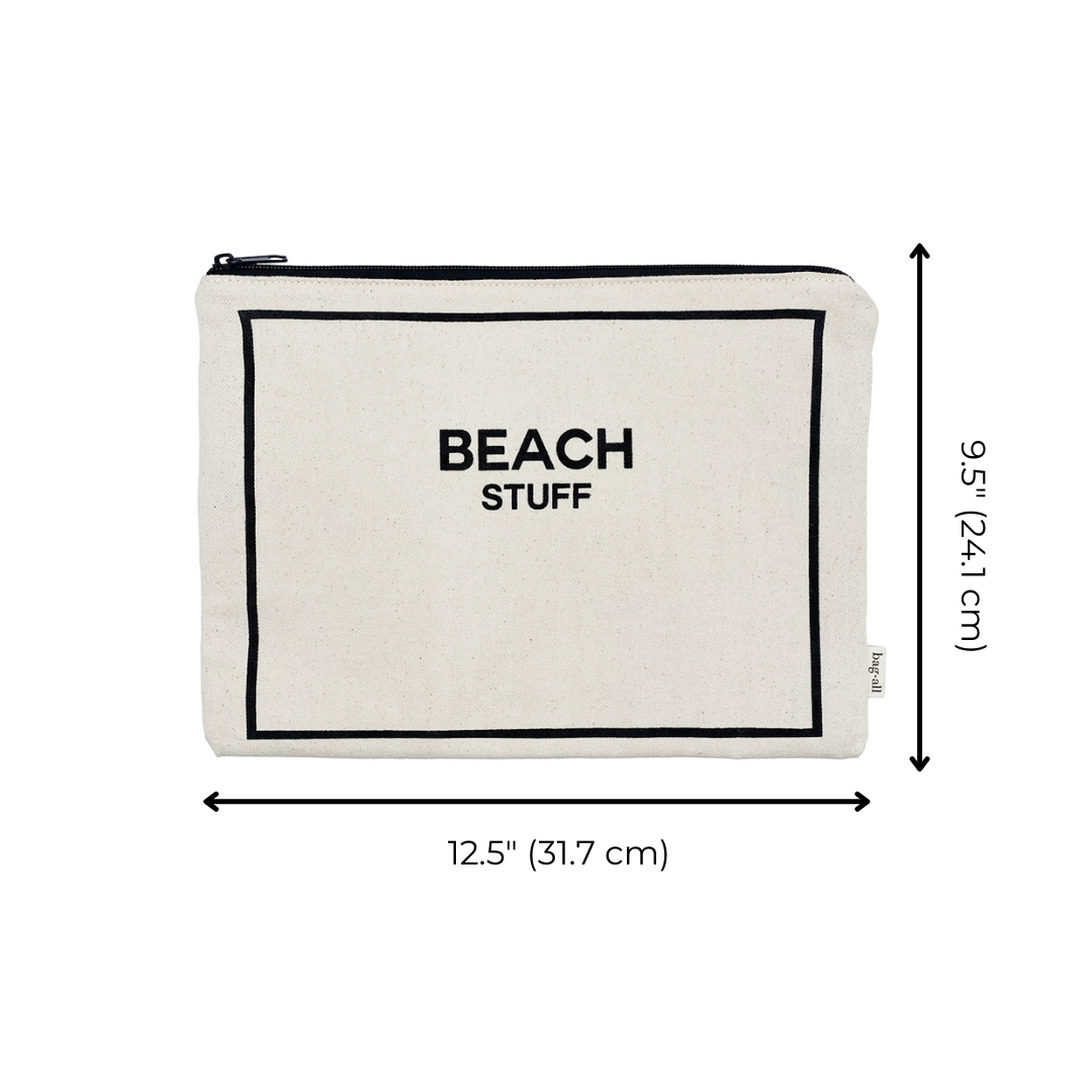 Bag-all Monogram Beach Pouch in cream cotton with black border, featuring "BEACH STUFF" text and waterproof lining for storing bathing suits and sunscreen