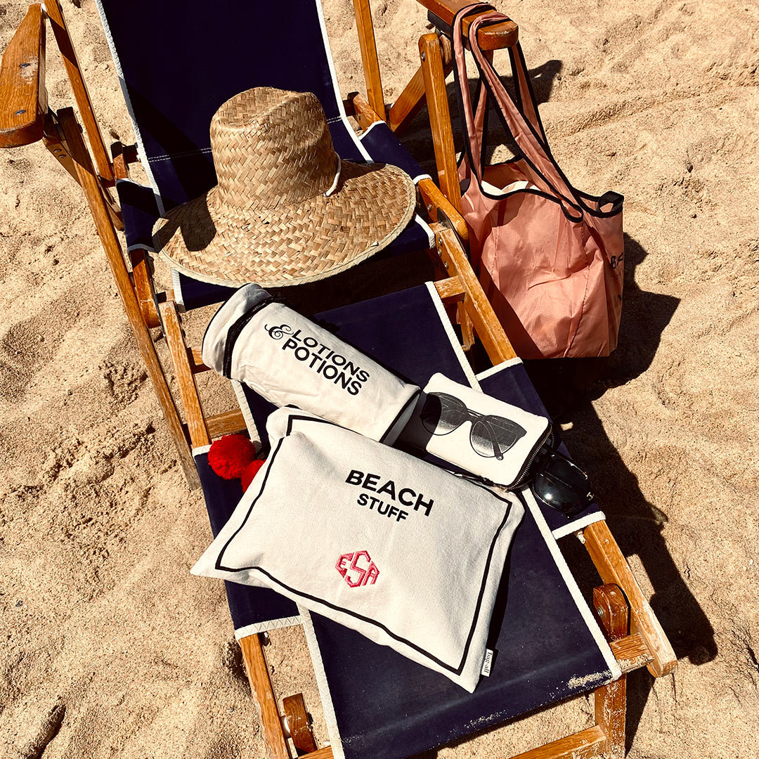 Bag-all Stylish Beach Essential Set in cream: wooden beach chair with straw hat, canvas beach bags, and waterproof pouches for organized beach day storage and style