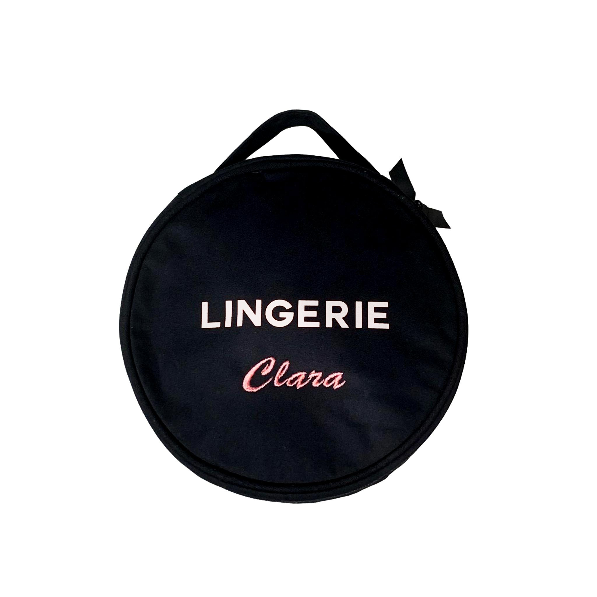 Bag-all Round Lingerie Case in black with white text print and personalized name, featuring carry handle and recycled ribbon zippers for elegant organization