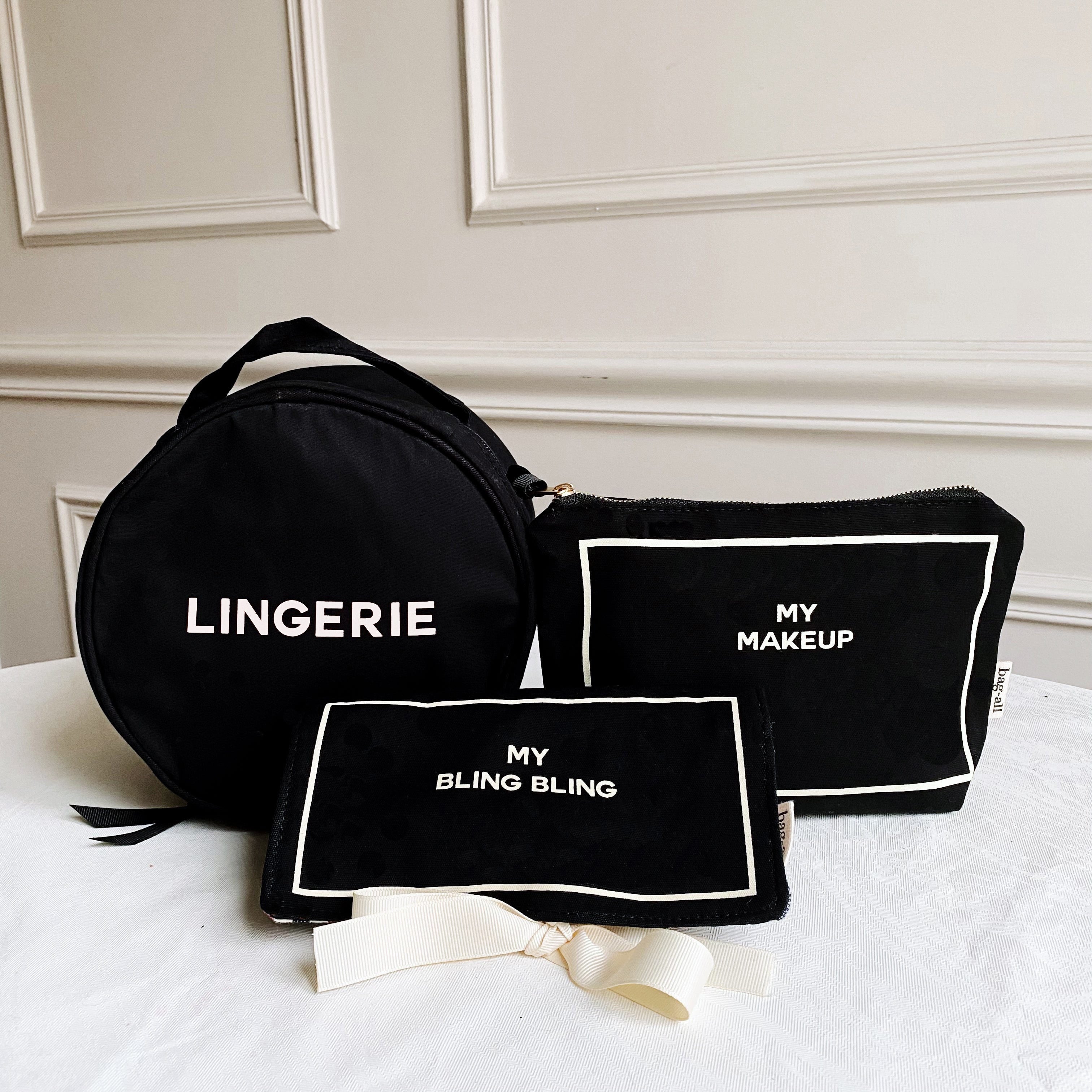 Bag-all Deal Gift Set for Her featuring black cotton cases: Round Lingerie Case, Jewelry Case, and Makeup Case with white text labels and striped interior lining