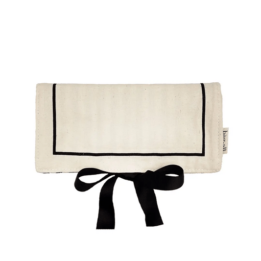Bag-all cream jewelry case travel roll with black trim and bow tie closure for organized jewelry storage