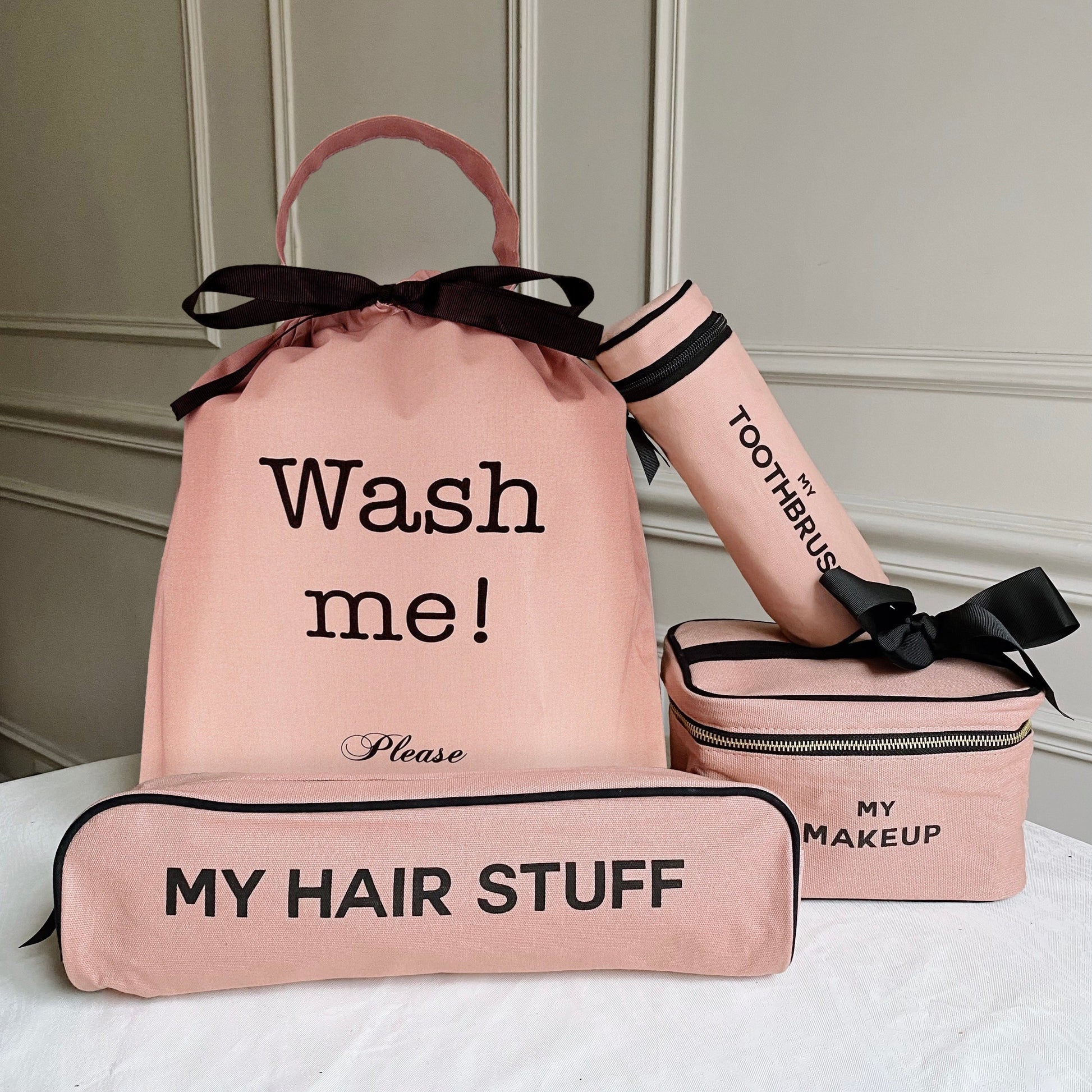 Bag-all Ultimate Gift Set featuring pink cotton travel cases - Wash Me laundry bag, makeup box, hair stuff case, and toothbrush holder with black bow accents