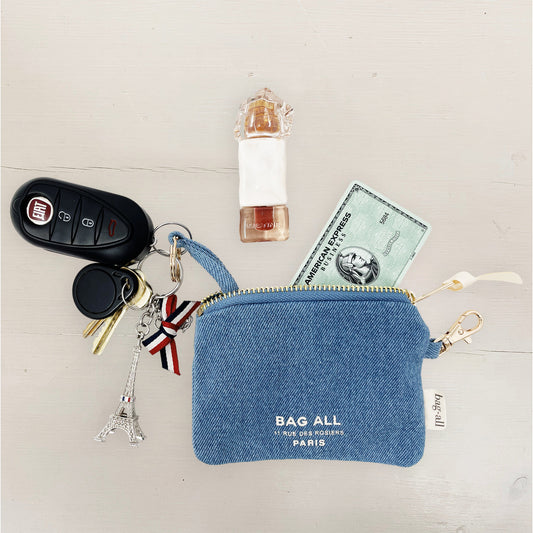 Bag-all Mini Trinket Pouch in Denim with zipper closure, displaying car keys, credit card and perfume bottle. Features Paris Eiffel Tower charm and key ring attachment.