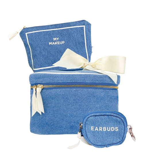 Bag-all Trendy Denim Travel Gift Set featuring makeup box, pouch, and earbuds case with cream ribbon accents and gold zippers, arranged stylishly on white background