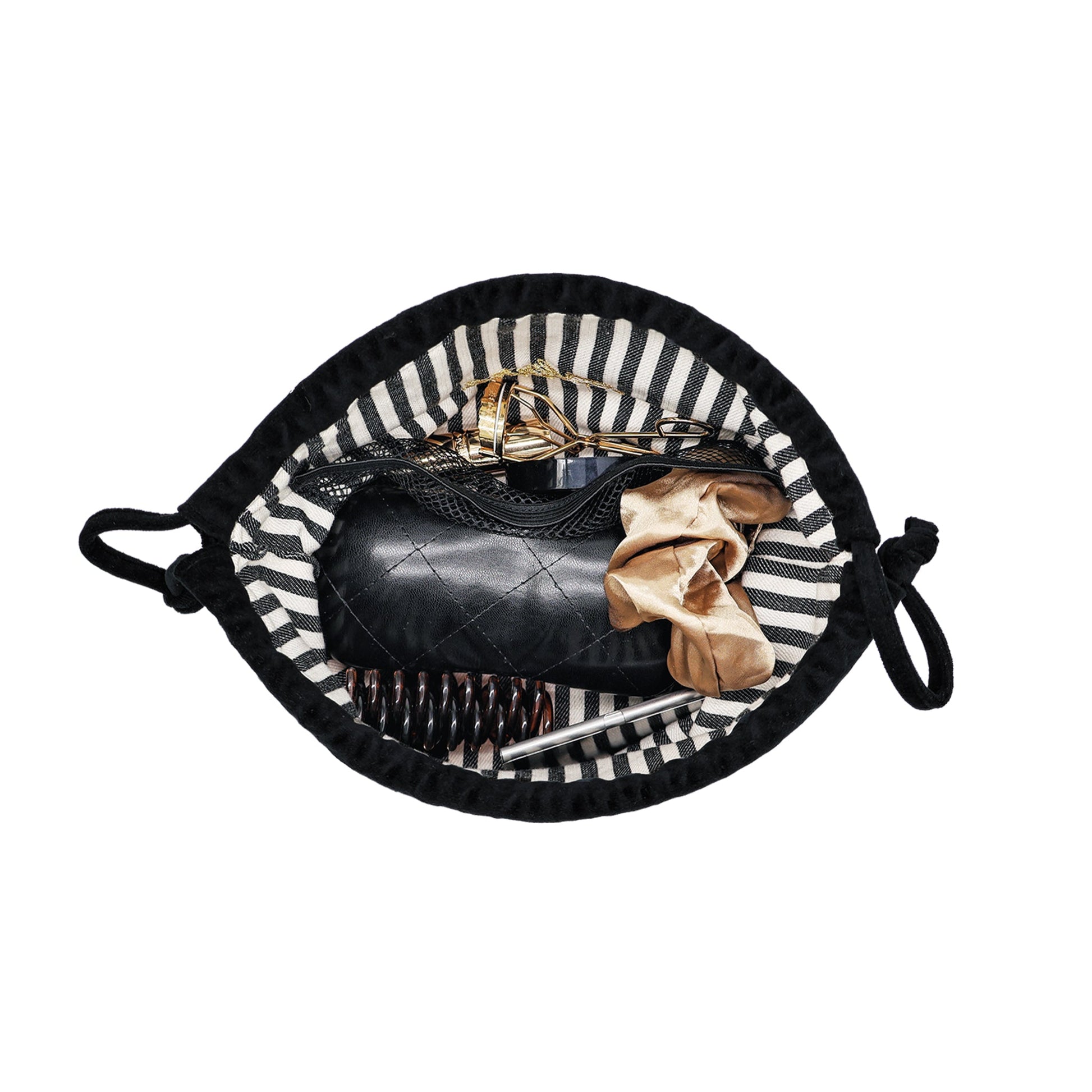 Black velvet drawstring makeup bag by Bag-all open showing organized essentials inside with striped interior lining