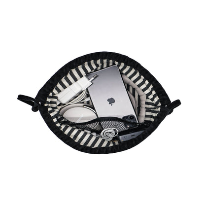 Drawstring black velvet tech pouch by Bag-all holding earbuds, charger, power bank, and cables neatly organized