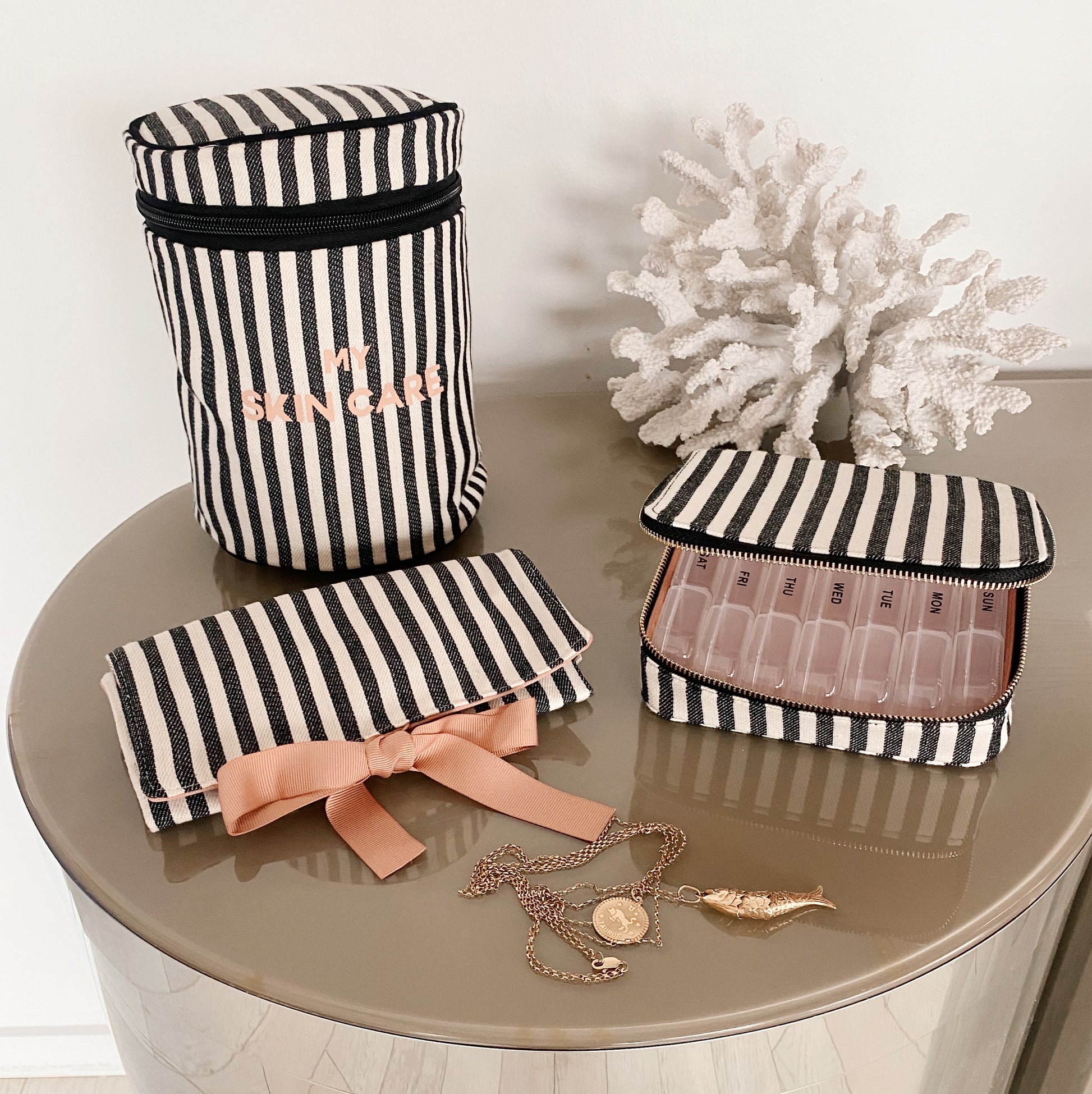 Bag-all Essential Gift Set Deal 3-Pack featuring striped cotton organizers: Round Skincare Case, Large Pill Case, and Jewelry Roll Pouch in black and white stripes with peach bow accents