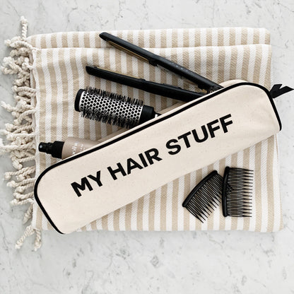 Cream Bag-all hair organizer pouch with black trim and MY HAIR STUFF text styled with combs brush and flat iron on striped towel