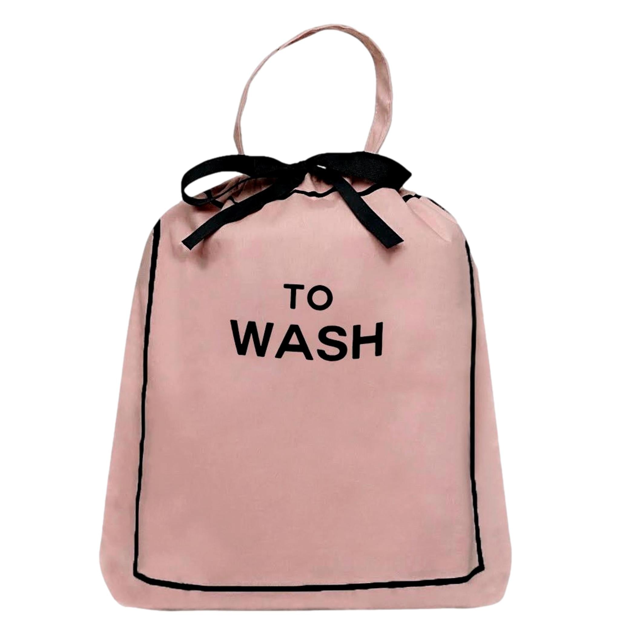 Bag-all To Wash organizing bag in blush pink cotton with black bow and text, perfect for sorting laundry and travel essentials