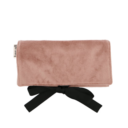 Bag-all Couture Jewelry Roll in pink velvet with black bow tie closure, featuring multiple compartments for organized jewelry storage and travel. Luxury eco-friendly jewelry organizer from Bag-all.