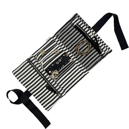 Bag-all black and cream striped jewelry organizer with multiple compartments storing bracelets rings and necklaces neatly