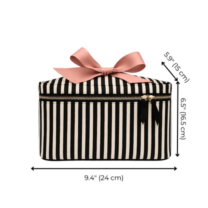 Bag-all medium striped makeup and toiletry case with gold zipper and pink bow accent on white background