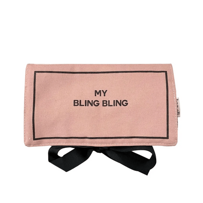 Folded blush pink Bag-all jewelry case with black ribbon tie and My Bling Bling text on white background