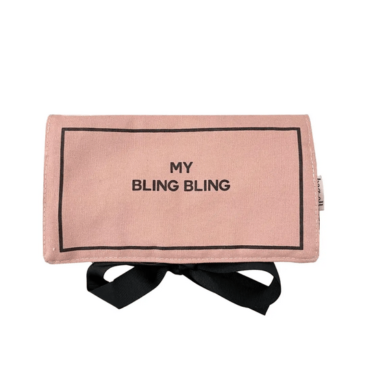 Folded blush pink Bag-all jewelry case with black ribbon tie and My Bling Bling text on white background