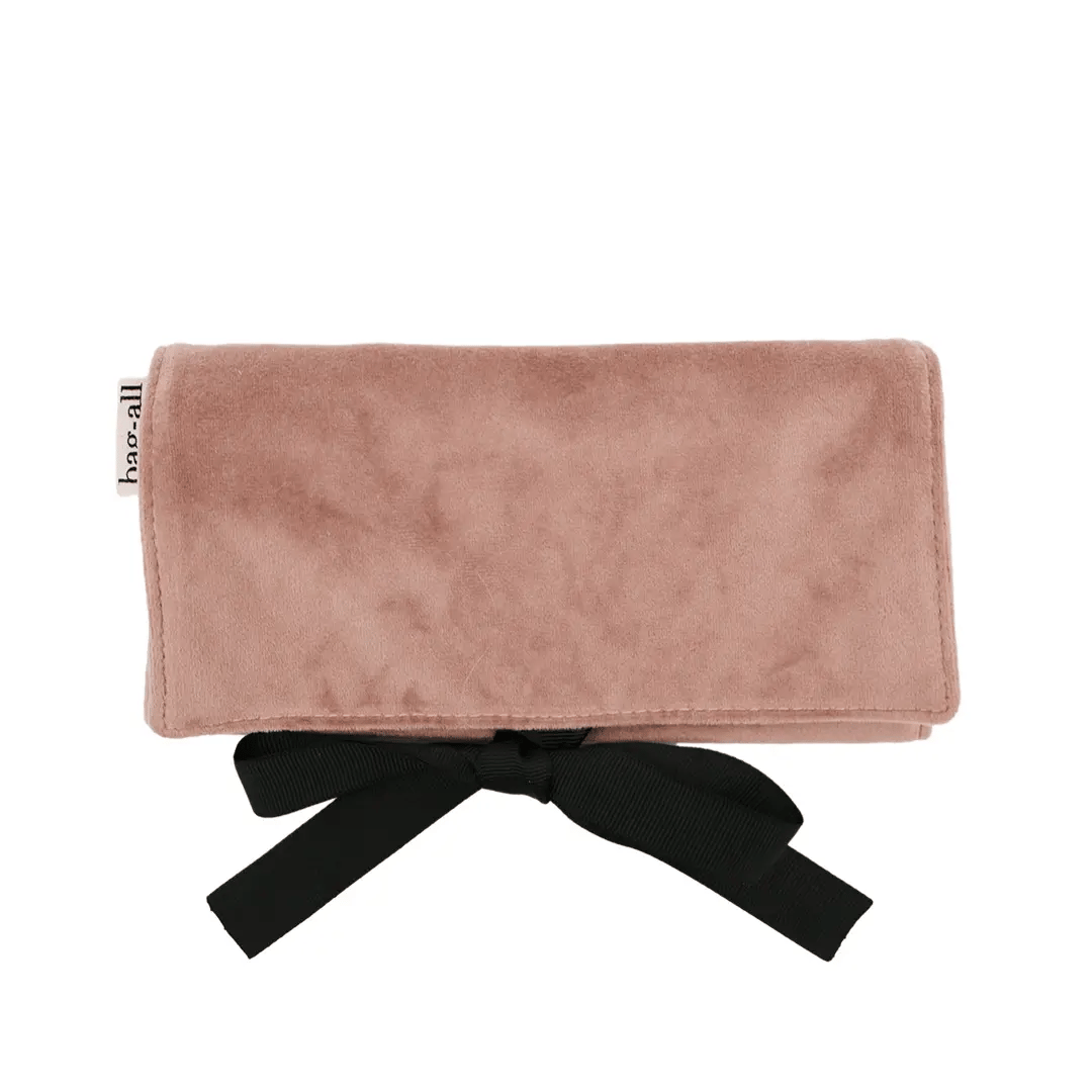 Pink eco velvet jewelry case with black ribbon tie, compact travel organizer by Bag-all on white background