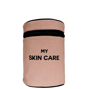 Bag-all Round My Skin Care Case in pink blush featuring black zipper and text, cylindrical waterproof organizer for beauty products and toiletries