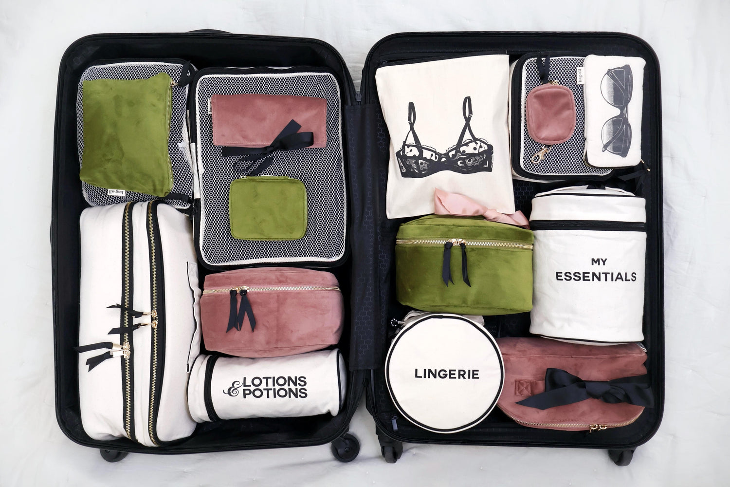 Open suitcase with organized compartments labeled for travel items.