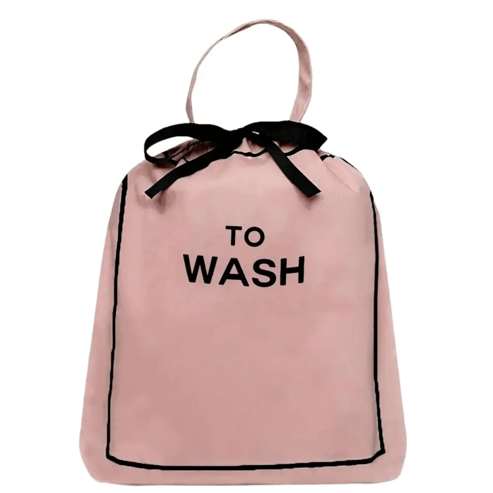 Bag-all To Wash Laundry Bag in pink cotton with black text and bow, featuring drawstring closure and hanging handle for closet organization and travel
