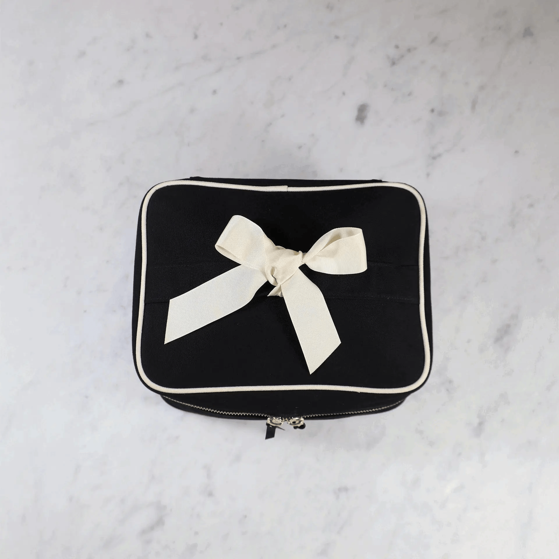 Black Bag-all vanity case with removable insert organizer and decorative grosgrain ribbon bow, perfect for makeup storage.