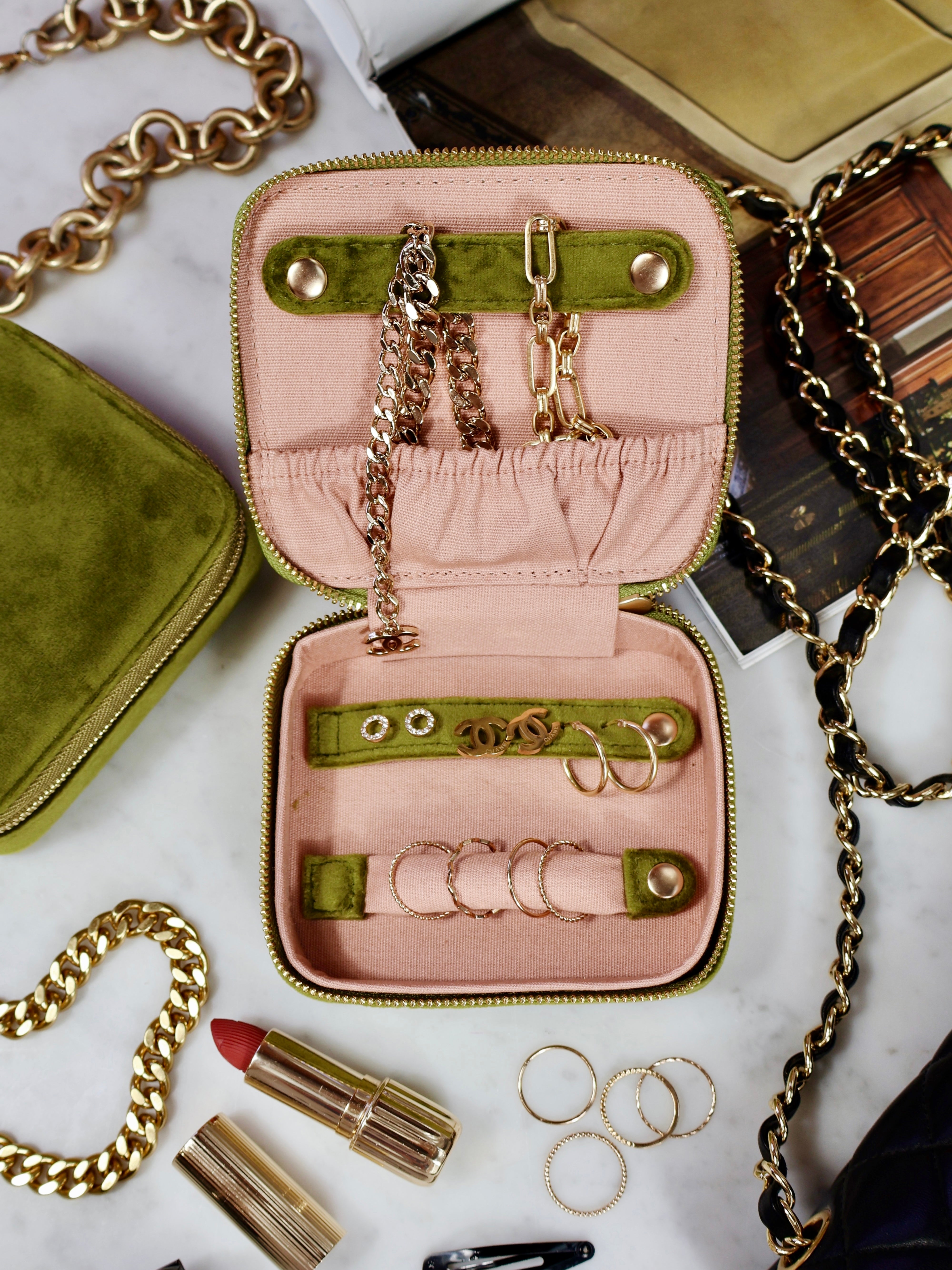 Bag-all Cute Jewelry Box in green recycled velvet with pink interior, featuring gold zipper, organized compartments for rings, necklaces, and earrings, monogrammable for personalization