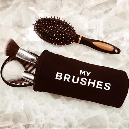 Black Bag-all hair tools organizer pouch with makeup brushes and a brush on a white background for easy storage