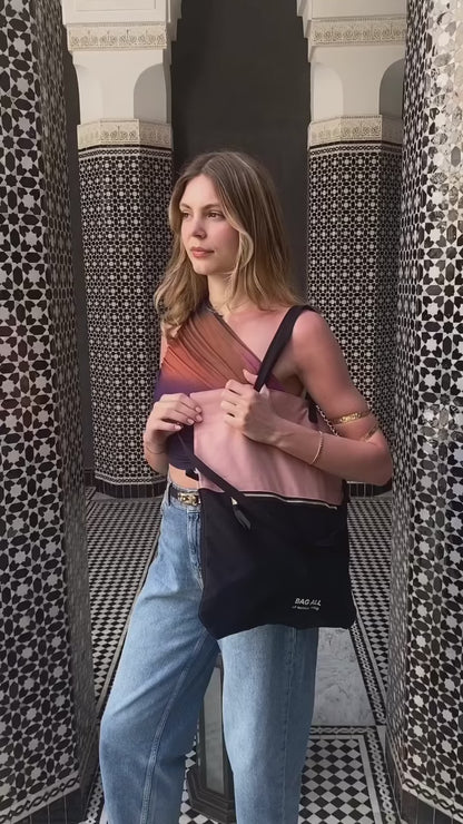 Woman wearing Bag-all 3-Way Tote in Pink/Black as a crossbody. Versatile, stylish, and perfect for travel