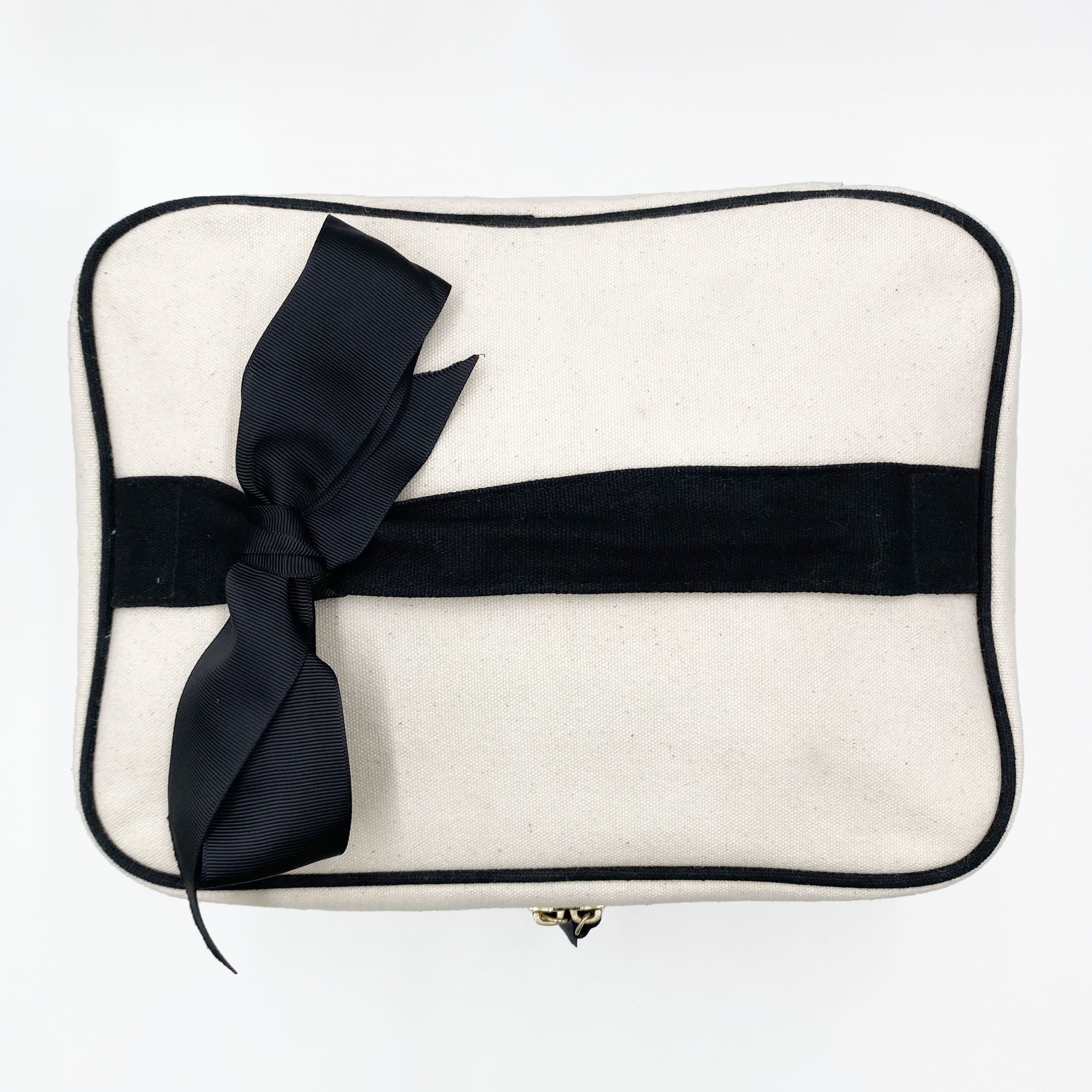 Cream Bag-all vanity case with black ribbon detail and black trim for makeup and toiletry organization