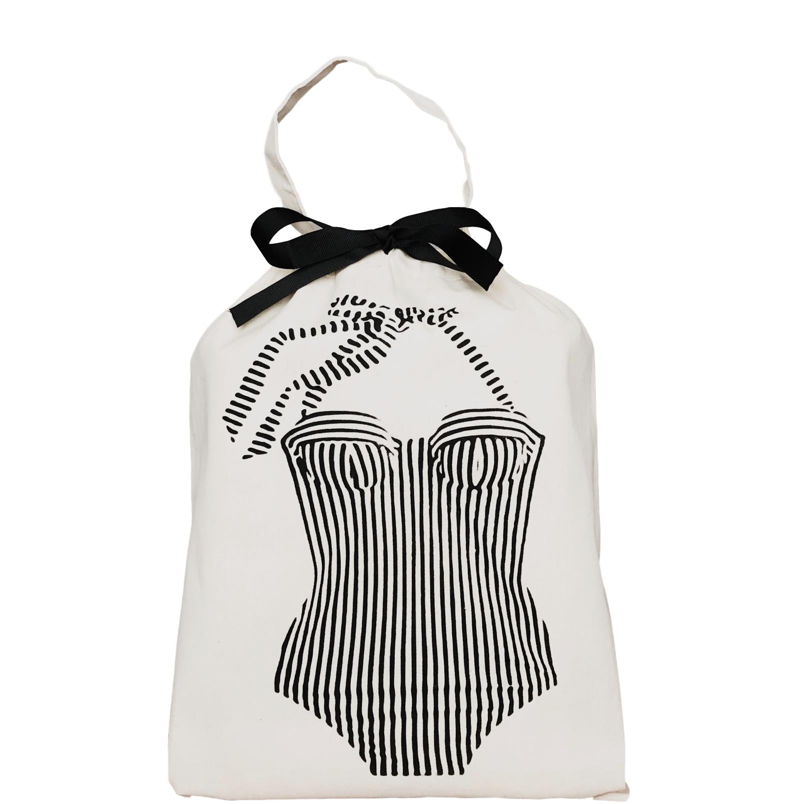 Bag-all vintage-inspired striped swimsuit organizer bag with black bow detail, featuring retro corset design in white cotton with black print