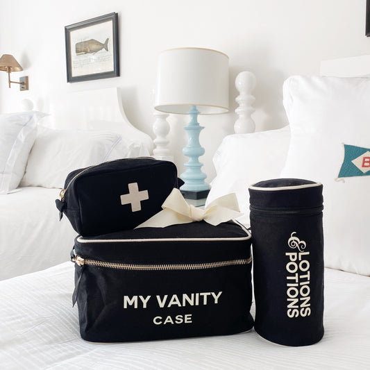 Bag-all My Vanity Case and Lotions & Potions holder in black cotton canvas with white embroidery, featuring first aid pouch with bow detail, perfect for toiletries and beauty essentials