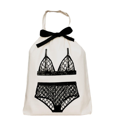 Bag-all London Lingerie Travel Bag in cream cotton with black lace lingerie print and bow detail, perfect for organizing delicate underwear during travel