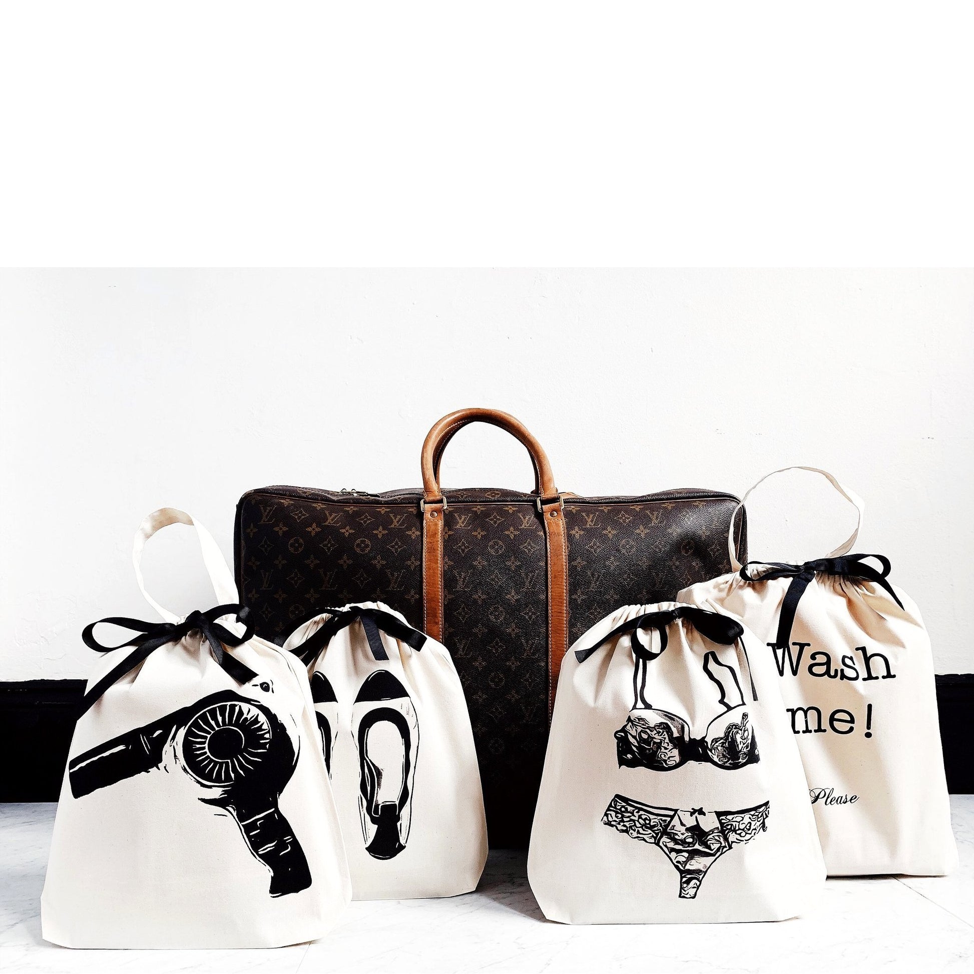 Bag-all Women's Travel Set 4-pack in Cream featuring organized travel bags for laundry, hairdryer, lingerie, and shoes, displayed with luxury travel duffle bag on white background