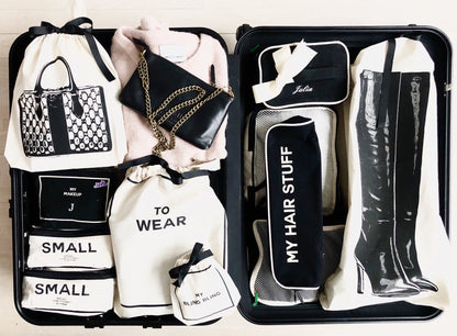 Bag-all Vintage Handbag Travel Bag in cream, featuring organized storage compartments with labeled cotton bags for accessories, boots, and clothing, displayed in sleek black suitcase interior